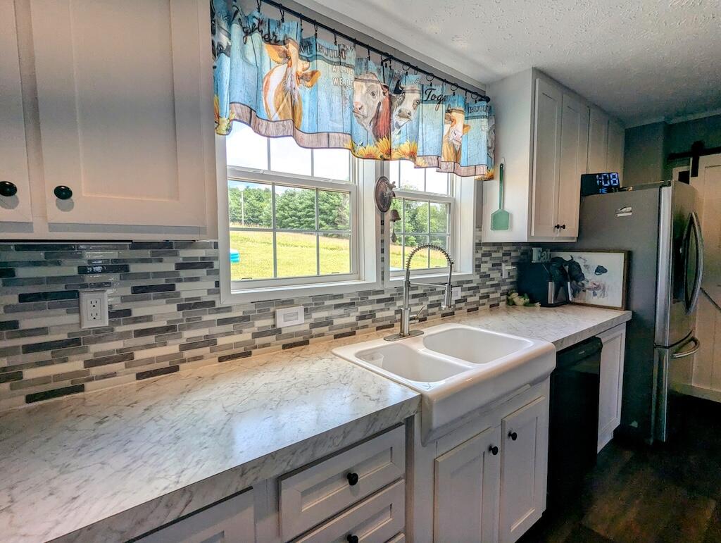 515 Windsor Road Northwest Willis, VA 24380 - Photo 7 of 30 a kitchen with a sink stove and cabinets