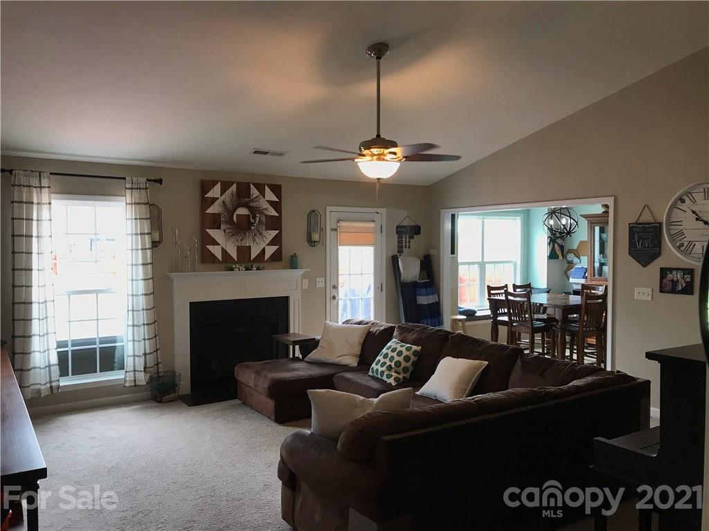 189 Pamlico Road Fletcher, NC 28732 - Photo 3 of 12 a living room with furniture a chandelier and a fireplace