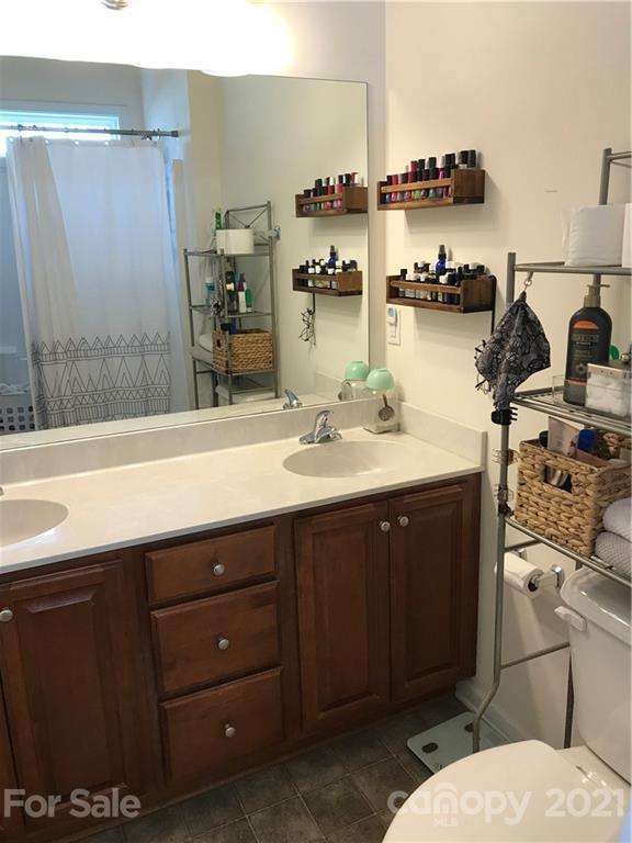 189 Pamlico Road Fletcher, NC 28732 - Photo 4 of 12 a bathroom with a double vanity sink toilet and mirror