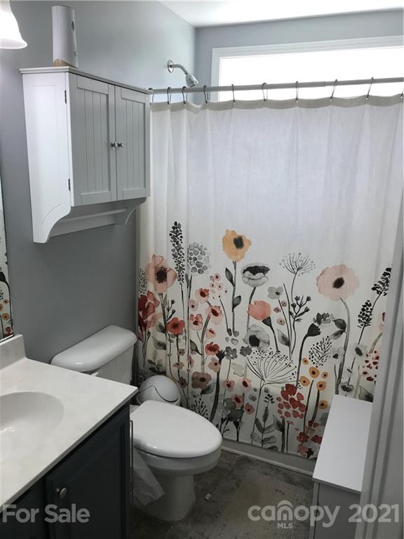 189 Pamlico Road Fletcher, NC 28732 - Photo 7 of 12 a bathroom with a toilet sink and shower curtain