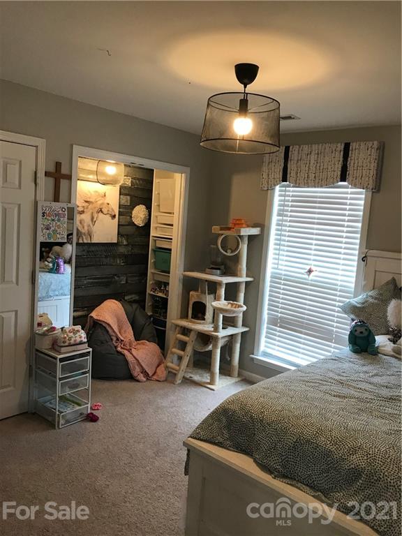 189 Pamlico Road Fletcher, NC 28732 - Photo 8 of 12 a bedroom with furniture and a window