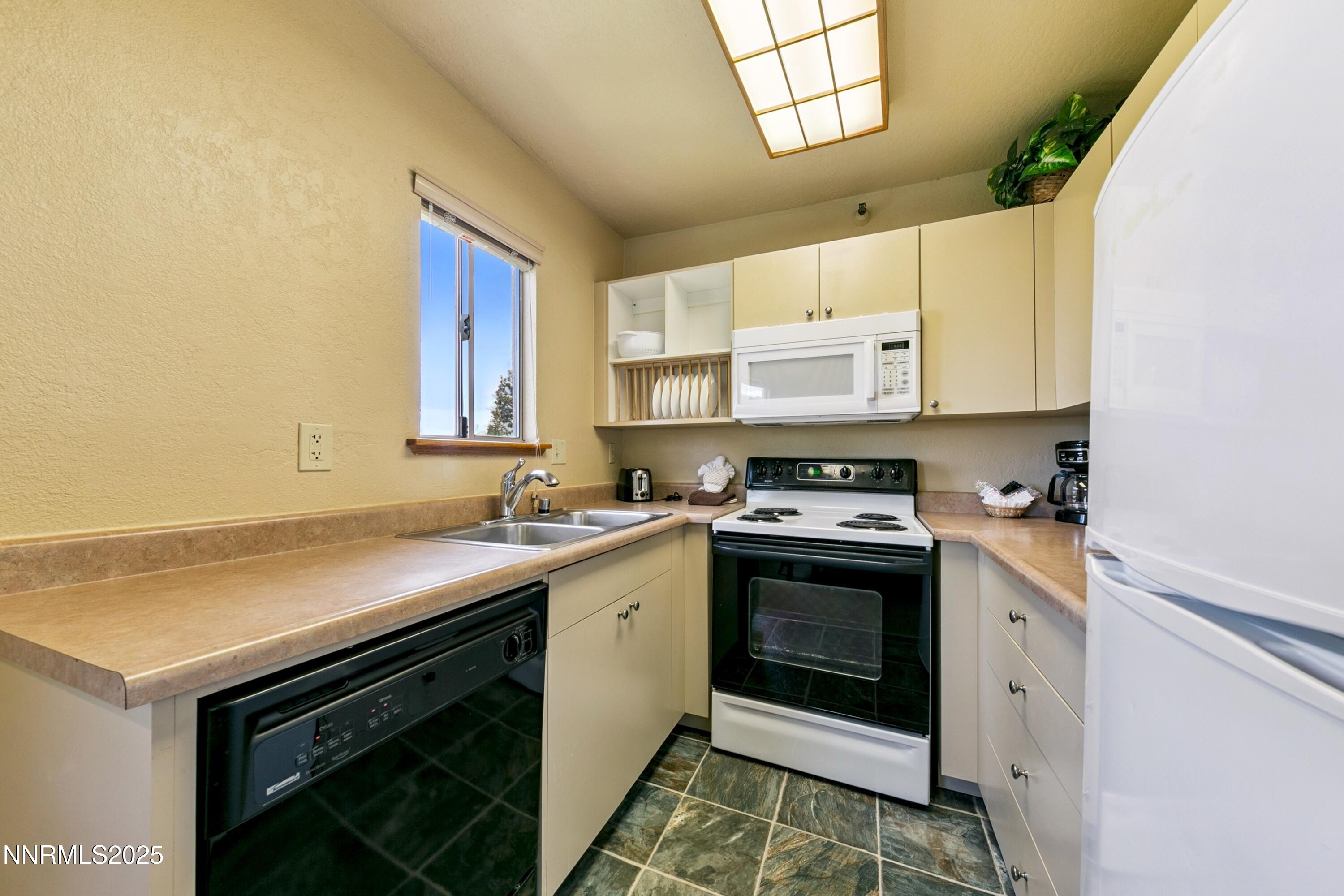 305 Galaxy Lane, Unit 2 Stateline, NV 89449 - Photo 4 of 46 a kitchen with a sink stove and cabinets