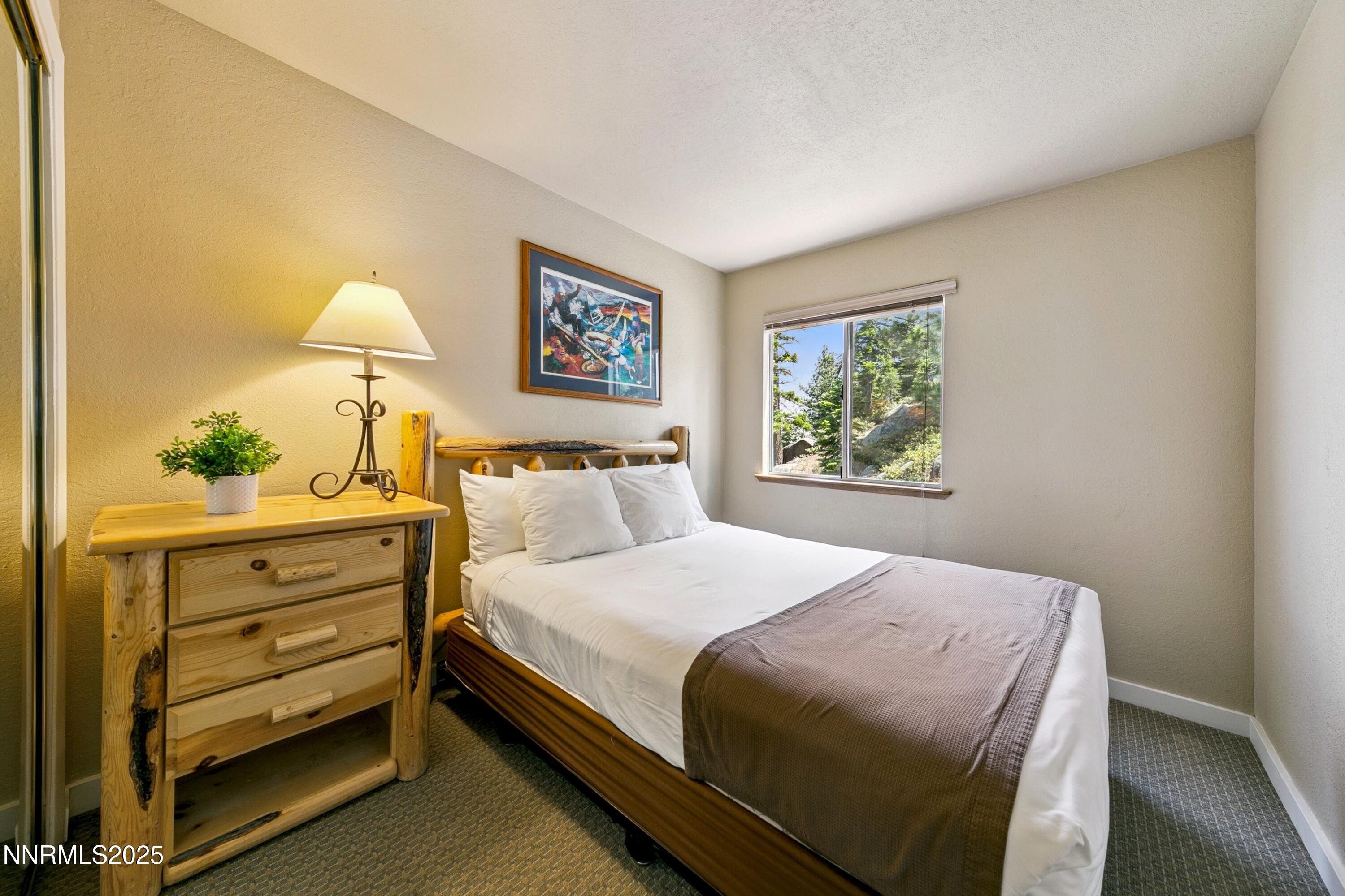 305 Galaxy Lane, Unit 2 Stateline, NV 89449 - Photo 5 of 46 a bedroom with a bed and a window