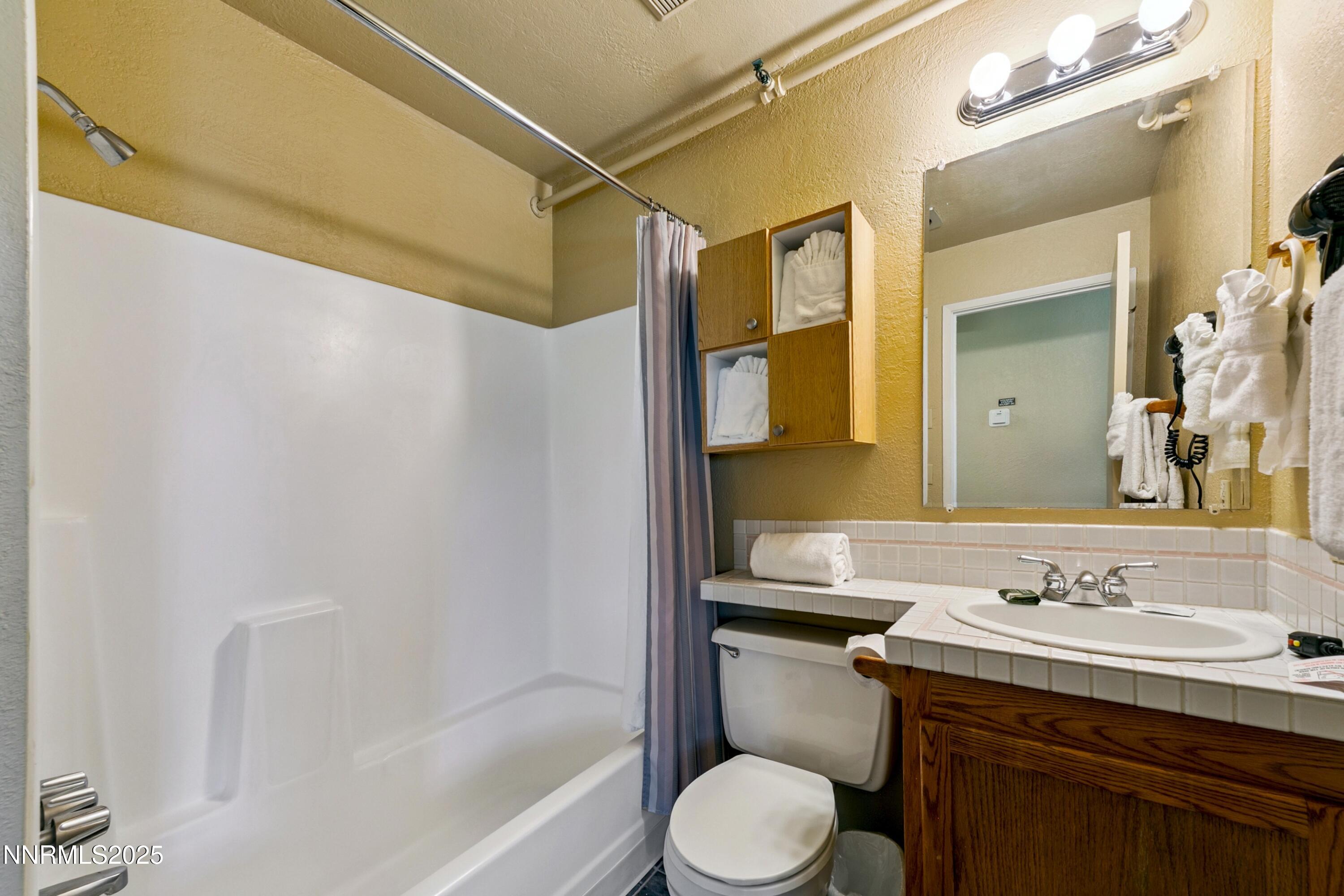 305 Galaxy Lane, Unit 2 Stateline, NV 89449 - Photo 7 of 46 a bathroom with a sink toilet and shower