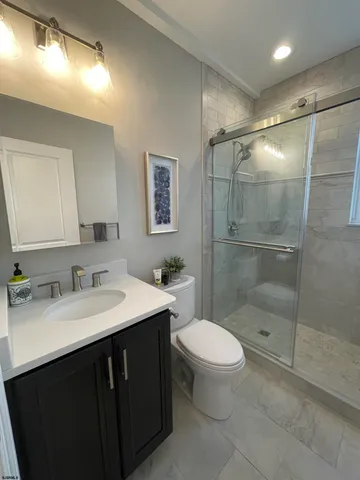 a bathroom with a sink toilet and shower