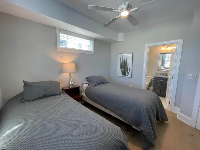 a bedroom with two beds and a chandelier