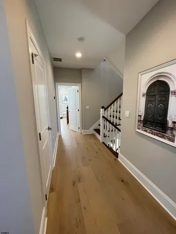 a view of a hallway with a door