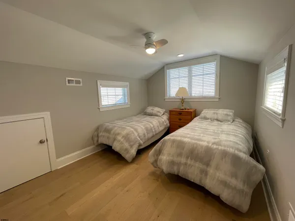 a bedroom with two beds and a window