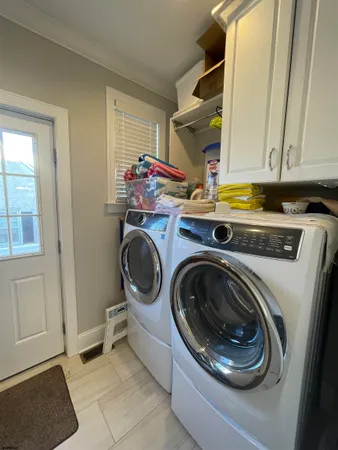 a utility room with sink dryer and washer
