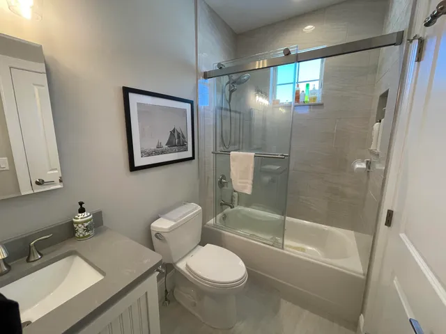 a bathroom with a sink toilet and shower