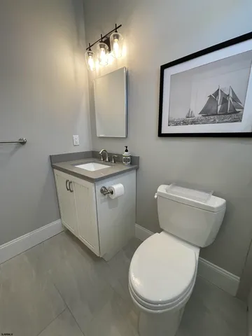 a bathroom with a toilet a sink and mirror