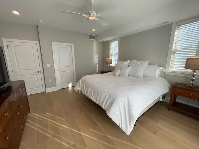 a bedroom with a bed and a flat tv screen