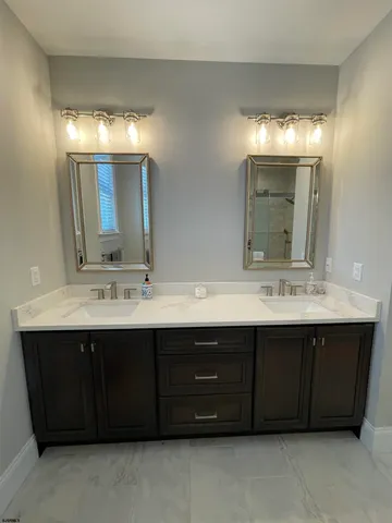 a bathroom with a double vanity sink and a mirror