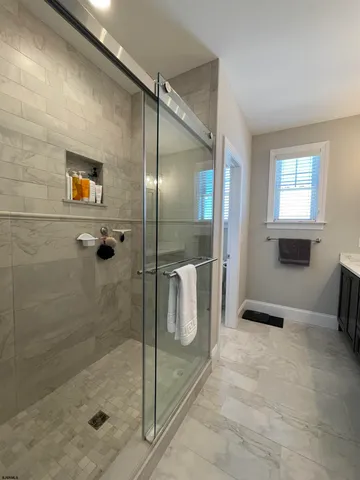 a bathroom with a shower and a sink
