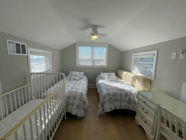 a bed room with two beds and a window