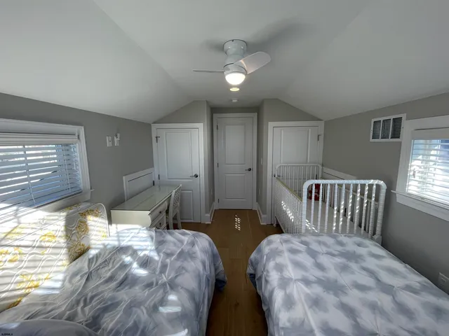a bedroom with two beds and a chandelier