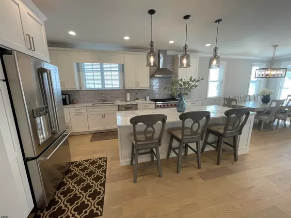 a large kitchen with a table and chairs