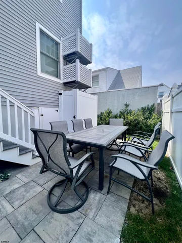 a backyard of a house with table and chairs