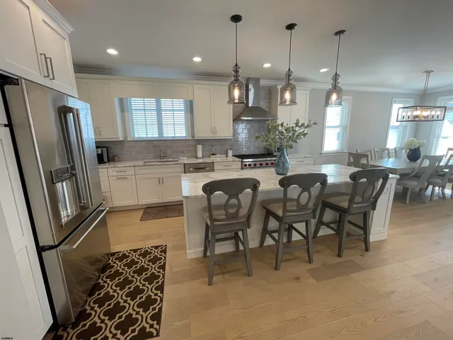 a large kitchen with a table and chairs