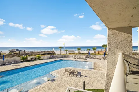 a view of a swimming pool with a lounge chairs