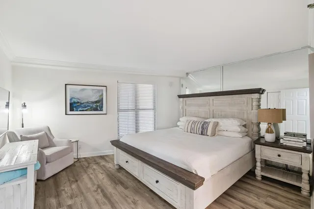 a view of a workspace with furniture and wooden floor