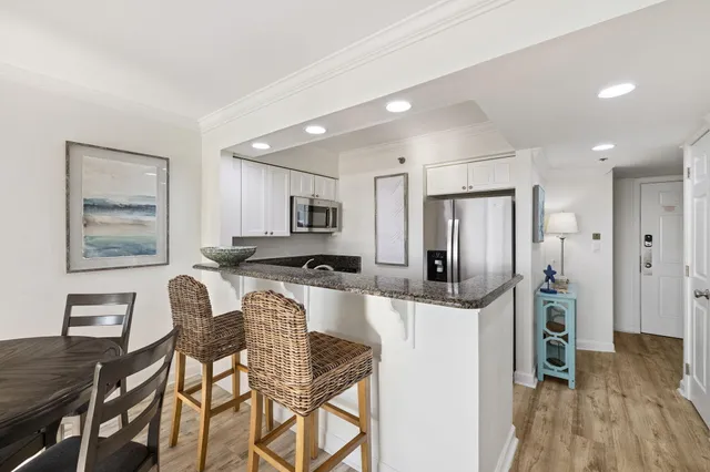 a kitchen with granite countertop a stove and a sink