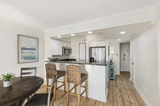 a view of living room with furniture and wooden floor