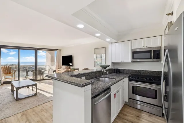 a living room with furniture a flat screen tv and a large window
