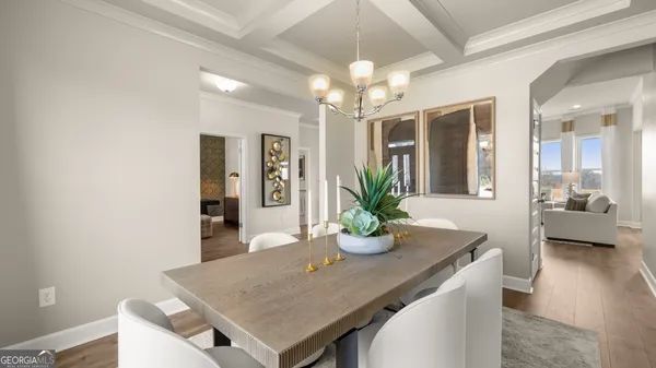a kitchen with kitchen island a sink a stove a refrigerator and white cabinets