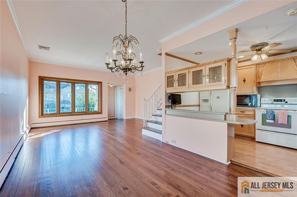31 Marie Road Fords, NJ 08863 - Photo 12 of 44 a living room with kitchen island wooden floor and stainless steel appliances