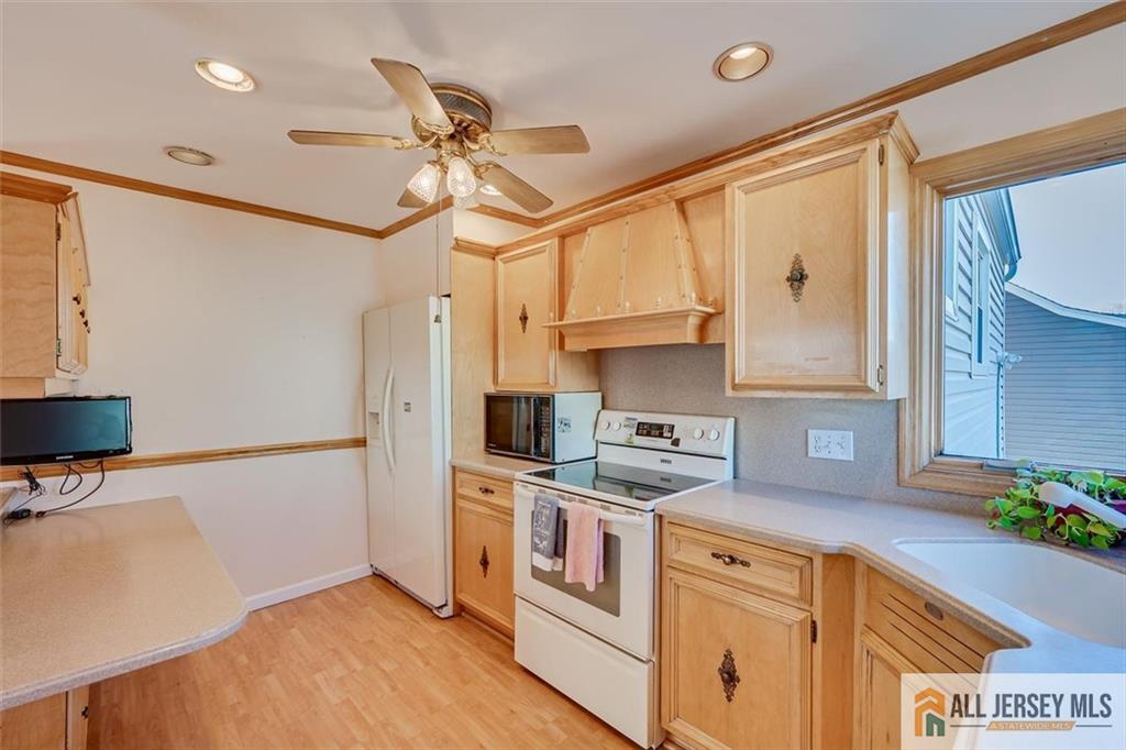 31 Marie Road Fords, NJ 08863 - Photo 14 of 44 a kitchen with stainless steel appliances granite countertop a sink a stove and a refrigerator