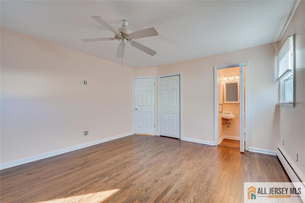 31 Marie Road Fords, NJ 08863 - Photo 19 of 44 an empty room with wooden floor fan and windows