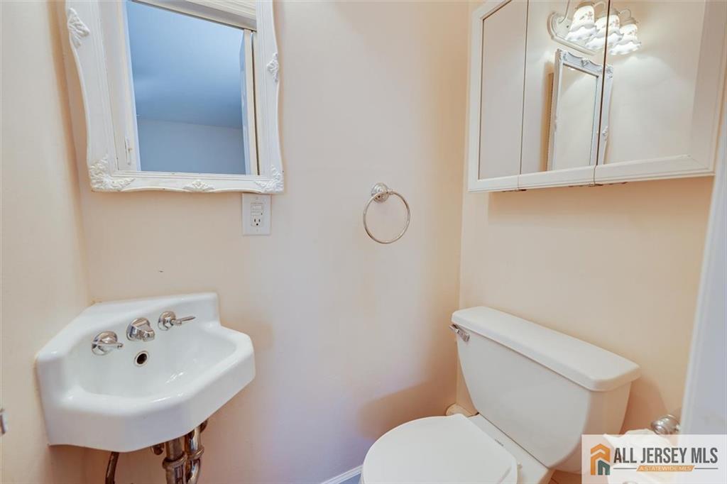 31 Marie Road Fords, NJ 08863 - Photo 20 of 44 a bathroom with a sink a mirror and a toilet