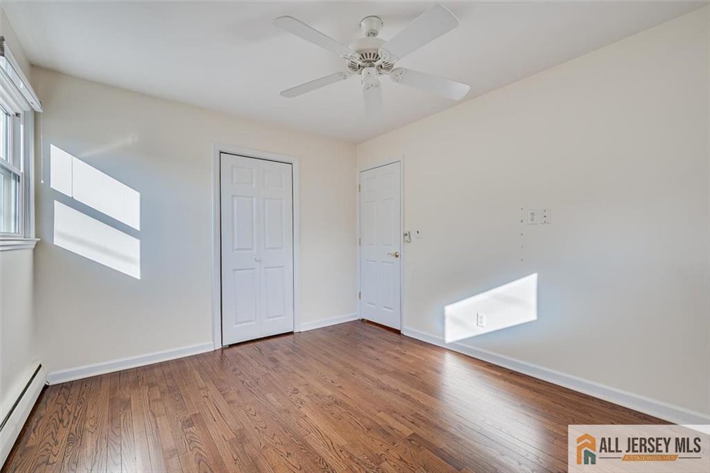 31 Marie Road Fords, NJ 08863 - Photo 22 of 44 an empty room with wooden floor and windows