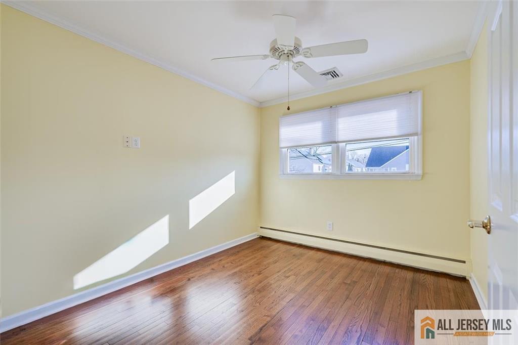31 Marie Road Fords, NJ 08863 - Photo 23 of 44 an empty room with wooden floor and windows