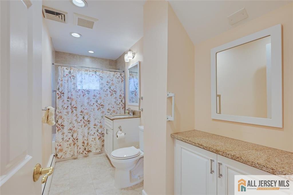31 Marie Road Fords, NJ 08863 - Photo 25 of 44 a bathroom with a granite countertop sink a toilet and shower