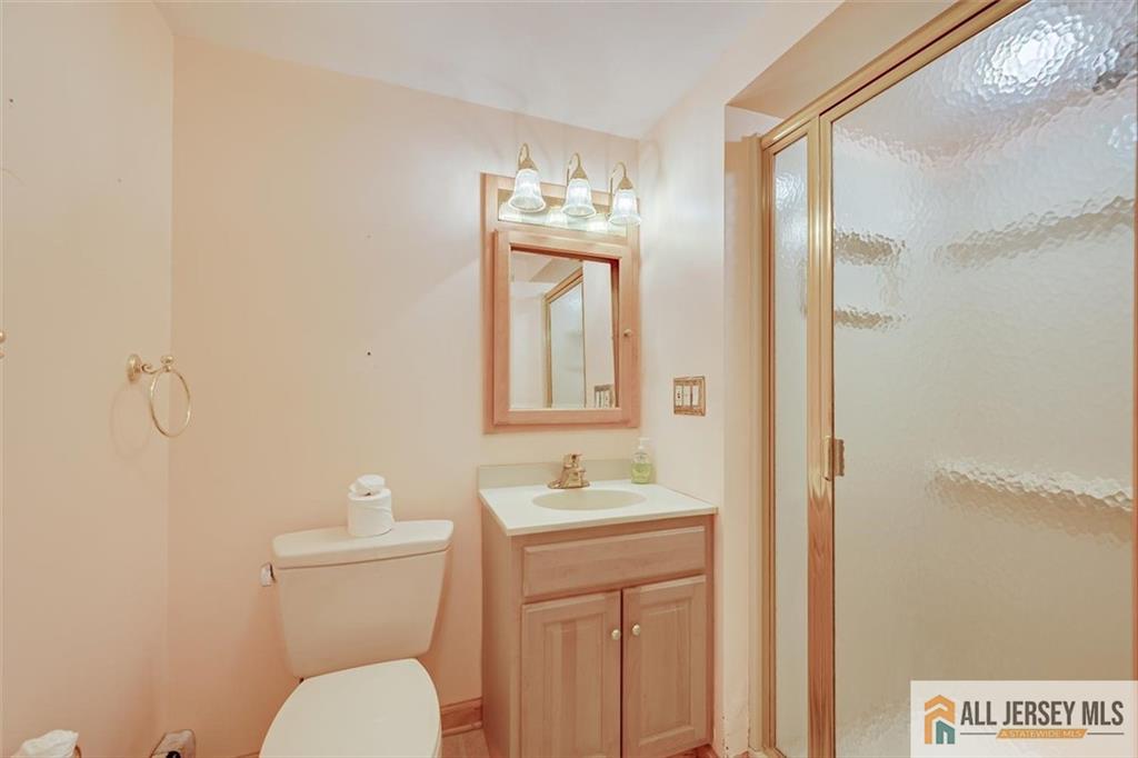 31 Marie Road Fords, NJ 08863 - Photo 32 of 44 a bathroom with a granite countertop toilet sink and mirror