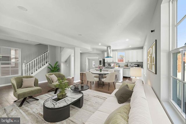 a kitchen with stainless steel appliances granite countertop a sink stove and cabinets