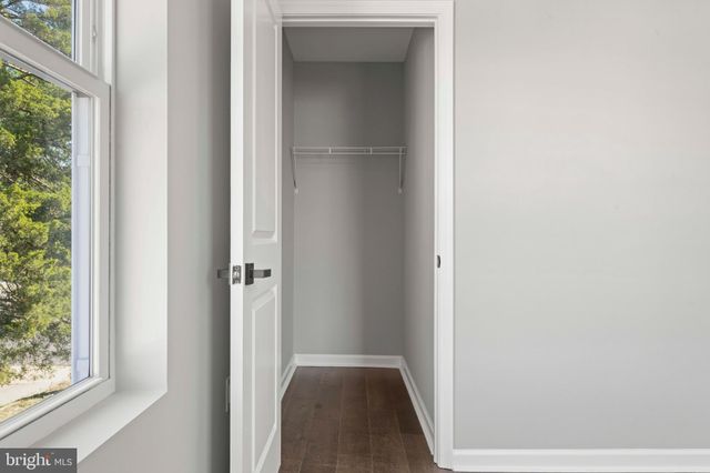 a view of a brick house with entryway and flower plants