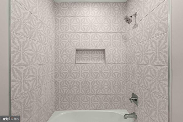 a bathroom with a shower and a sink