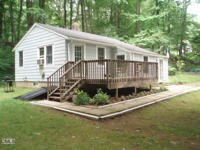 7 Overlook Knoll Road Newtown, CT 06482 - Photo 1 of 1 a white house that has a small yard and large trees
