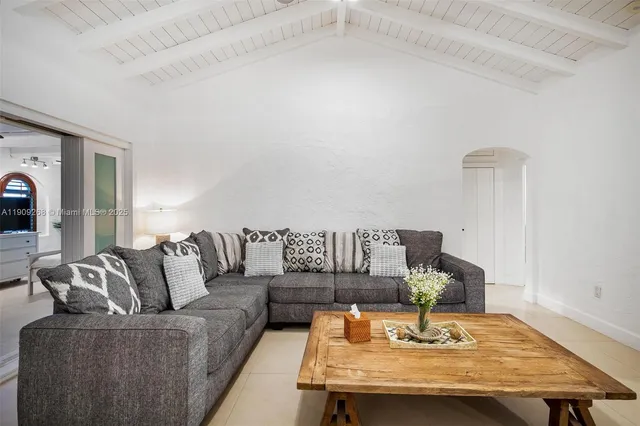 a view of a dining room with furniture and a potted plant