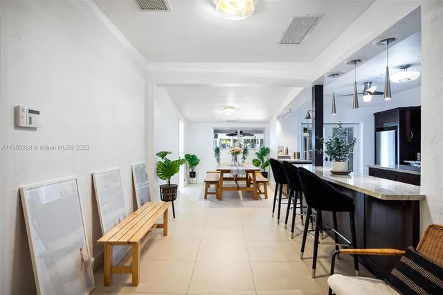 a dining room with furniture and chandelier