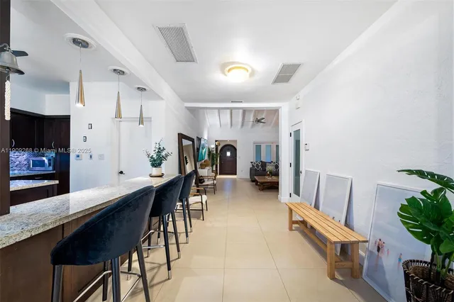 a living room with furniture and large windows