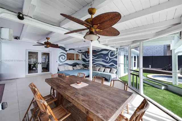 a view of a house with a backyard pool and sitting area