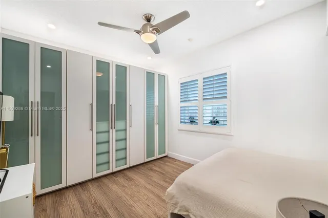 an aerial view of residential houses with outdoor space and lake view