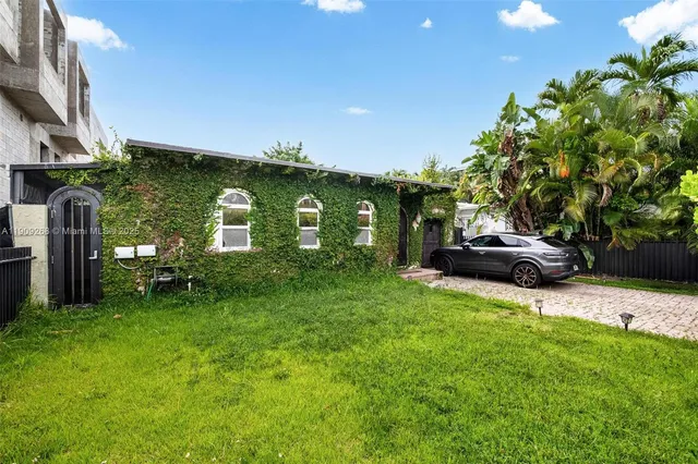 an aerial view of residential houses with outdoor space and lake view