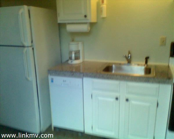 16 Hye Road, Unit MAIN & GUEST Edgartown, MA 02539 - Photo 22 of 32 a kitchen with a sink and a mirror