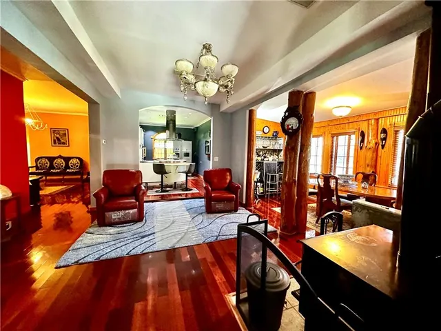 a living room with furniture fireplace and large windows