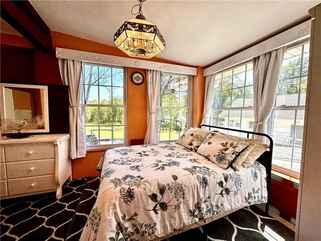 a bedroom with a bed and a large window